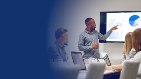 A group of people looking at data in a meeting