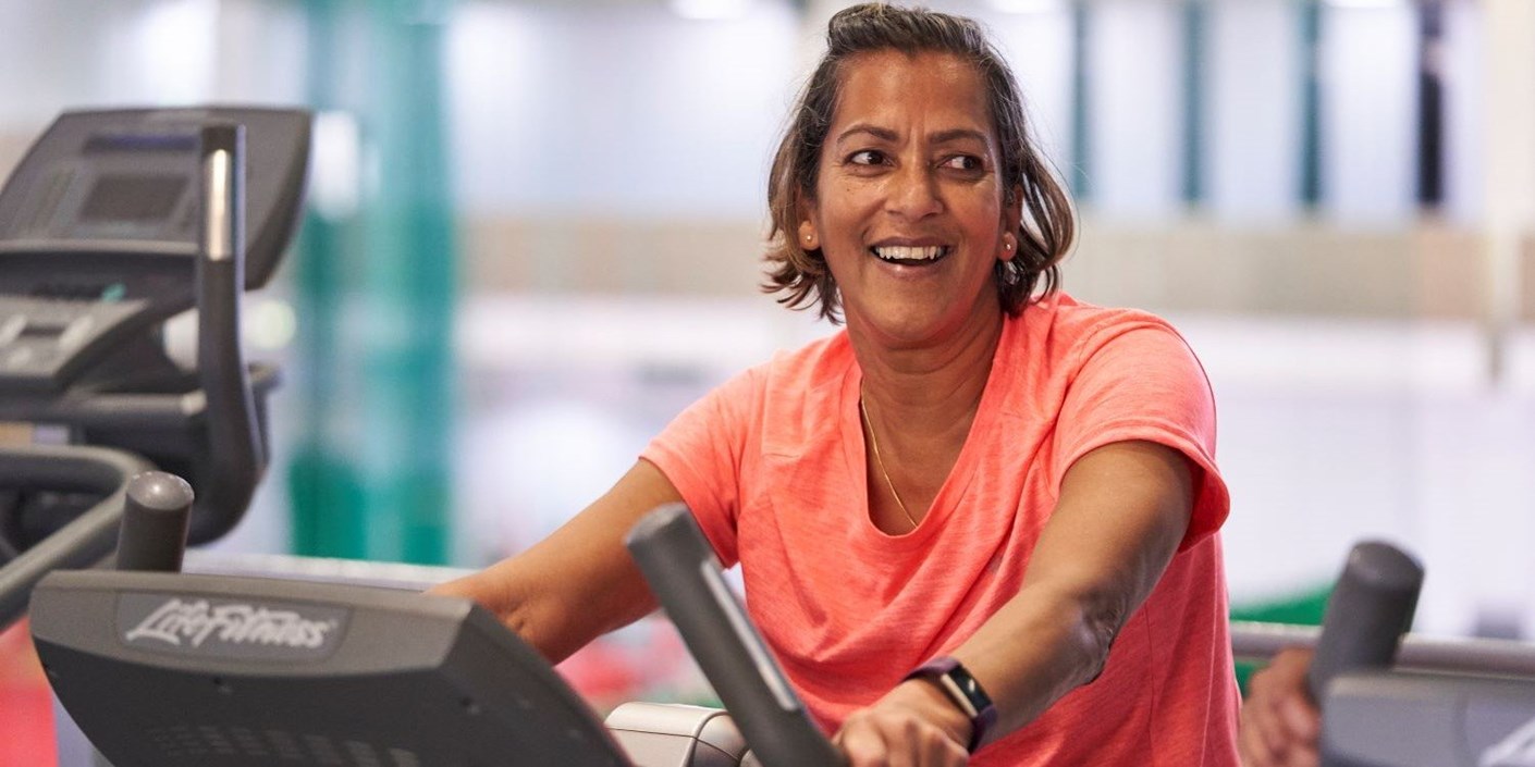 A woman using an exercise bike at a public leisure centre