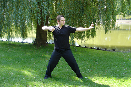 A person doing the archer pose in Qigong