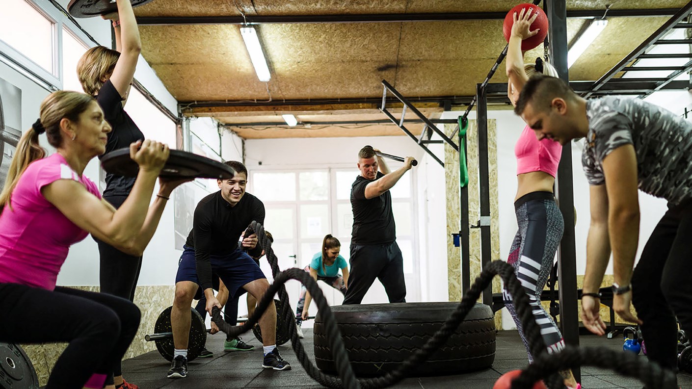 Many different people doing various exercises that form part of bootcamp training