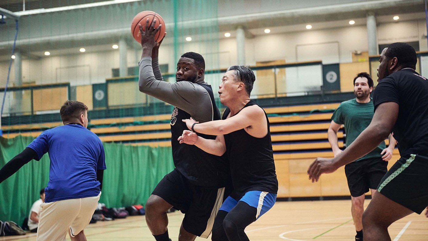 men playing basketball in sports hall