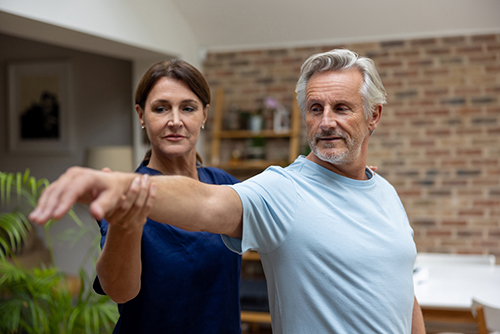 A trainer helping a client with their form