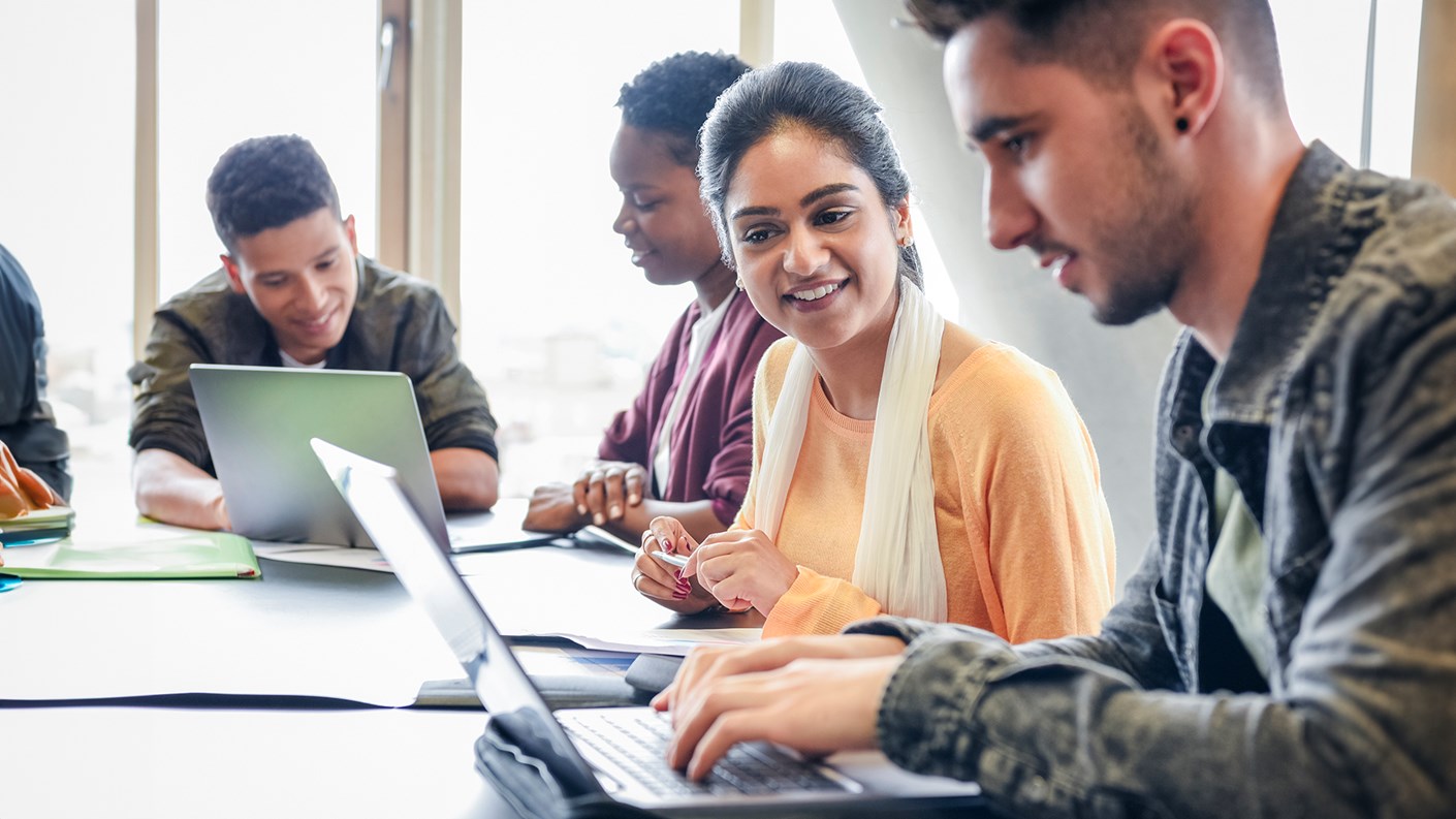 A group of people working on laptops