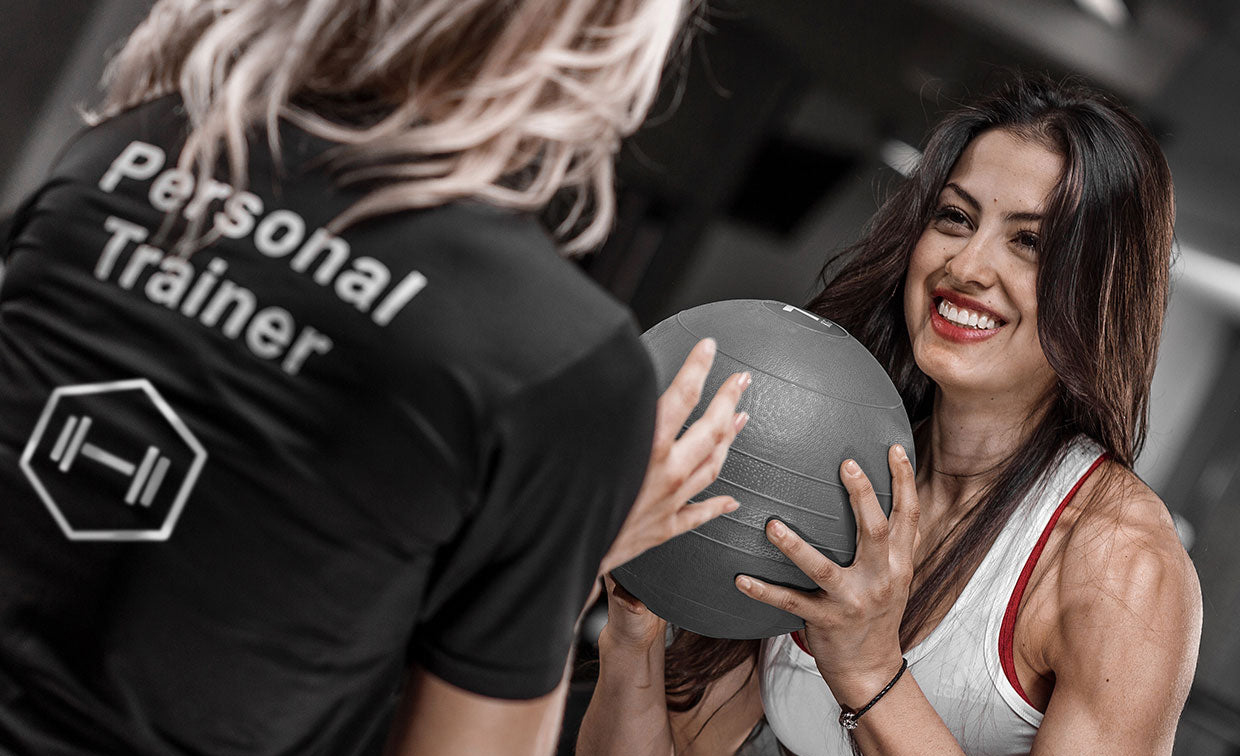 A personal trainer helping someone train