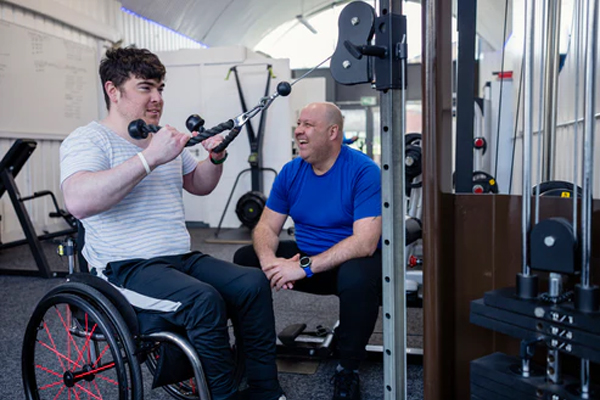 Man in wheelchair doing gym workout