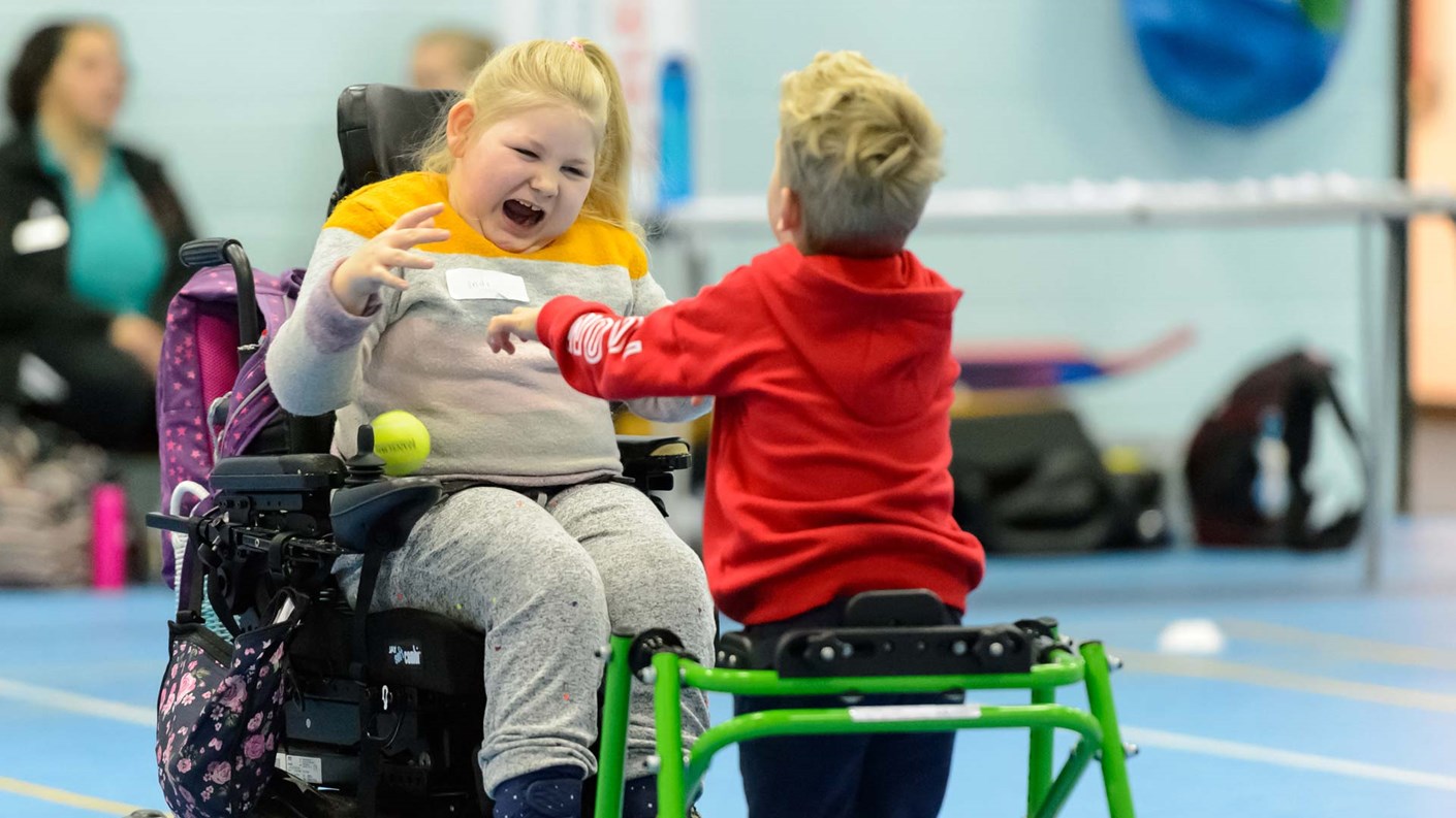 girl in wheelchair catching ball