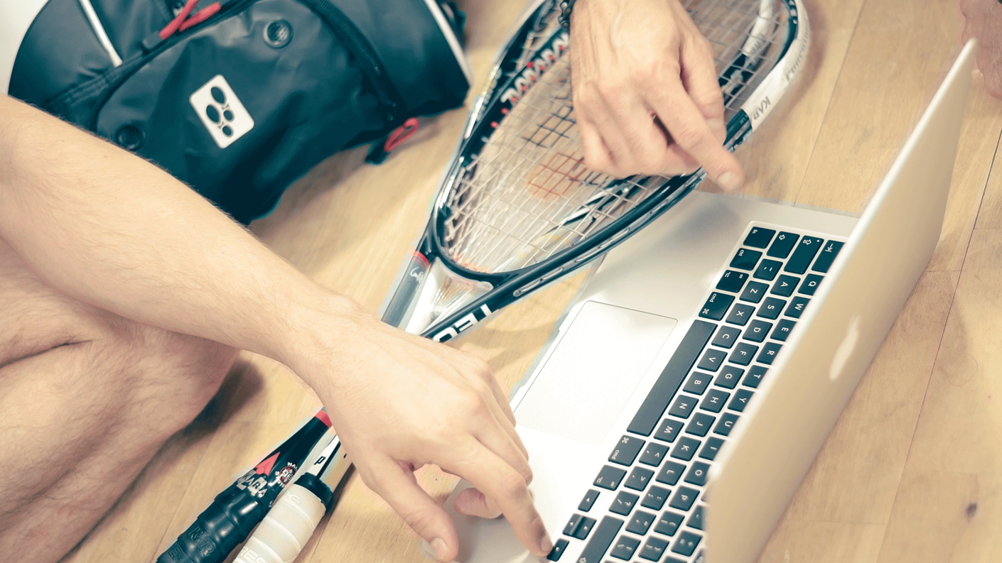 squash racket next to laptop