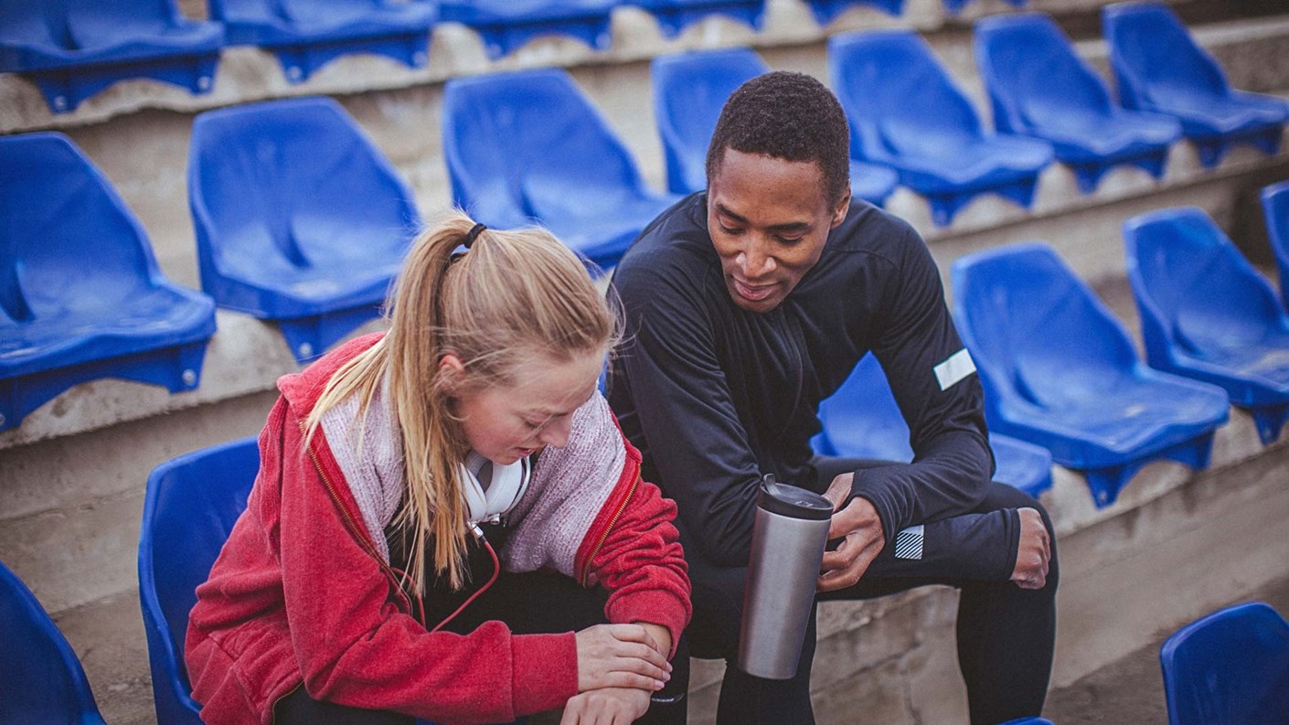 coach in stands with athlete