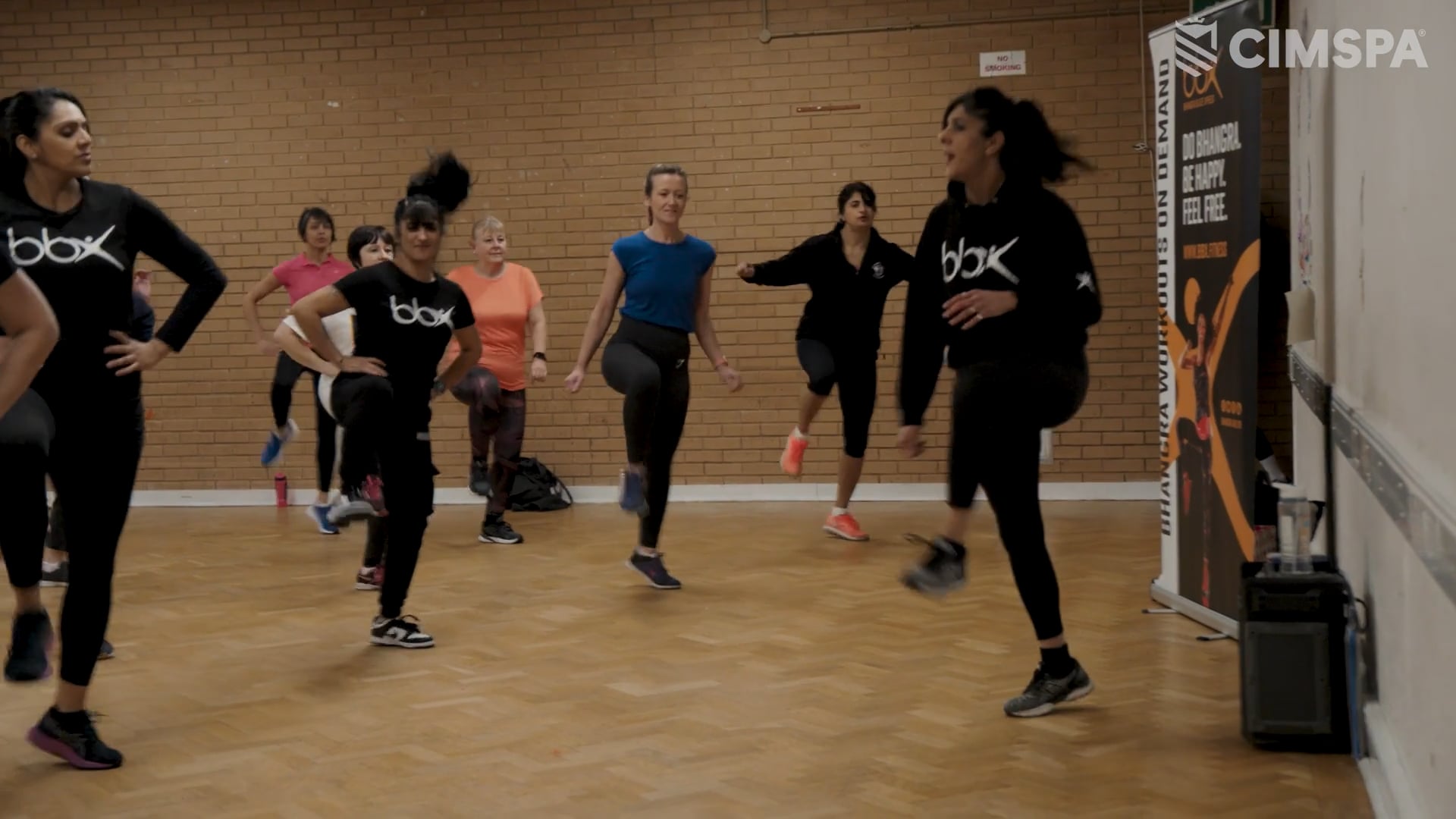 A group exercise instructor running a bhangra inspired class