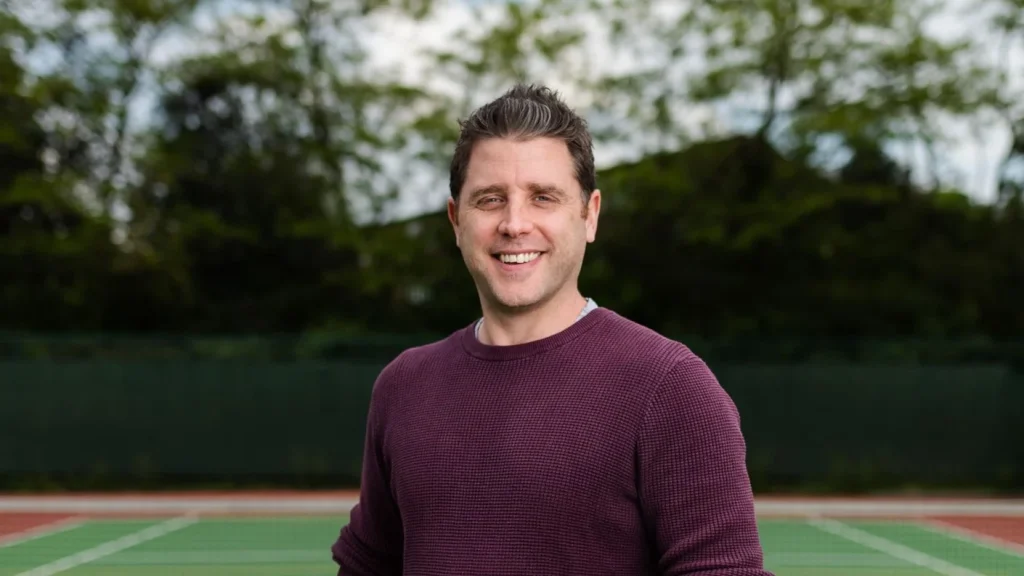 A person standing on a tennis court