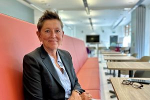 Tara Dillon, sat down on seating facing camera