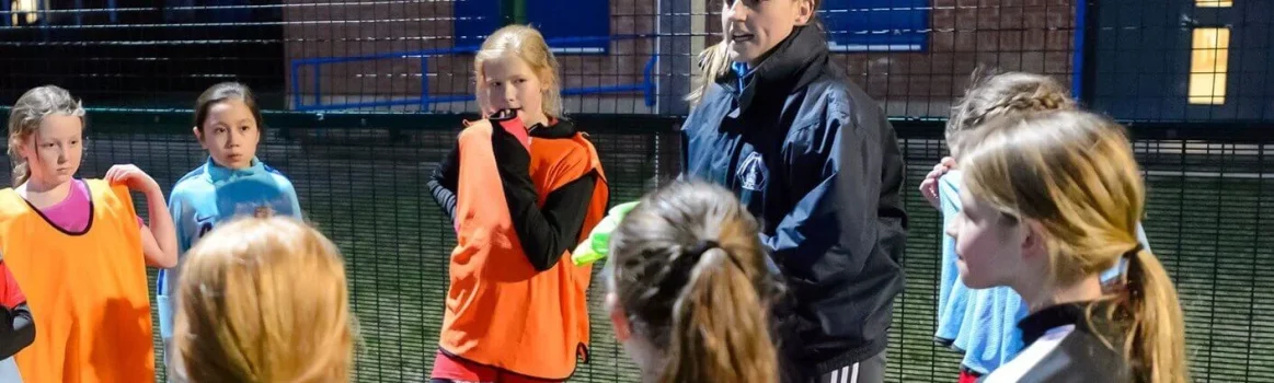 Coach leading a football team