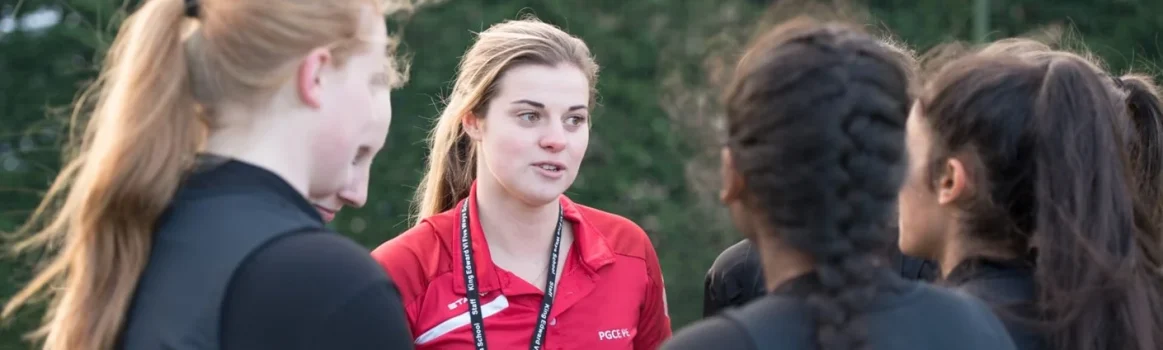 Higher Education tutor talking to students